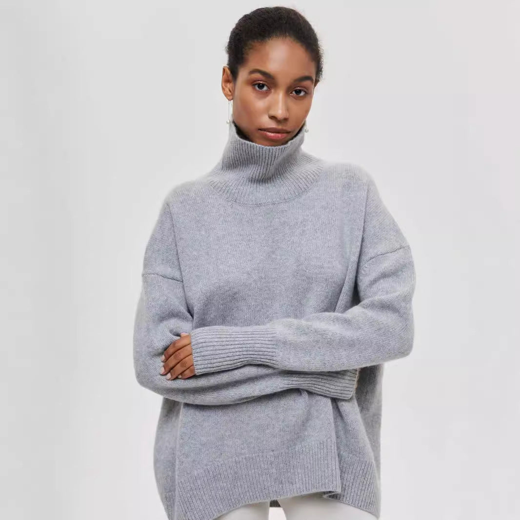 Person wearing a gray turtleneck sweater on a light gray background