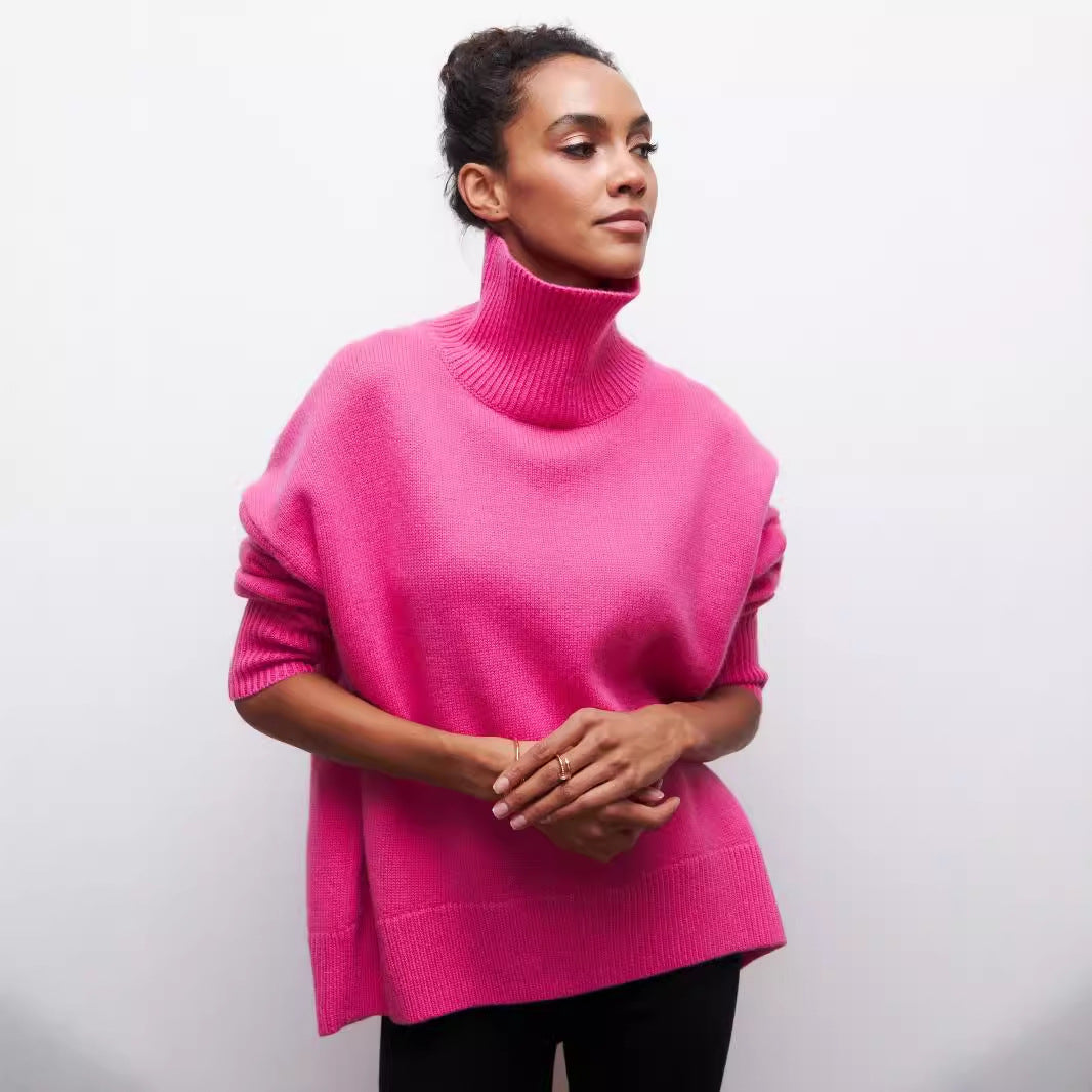 Person wearing a bright pink turtleneck sweater against a plain background